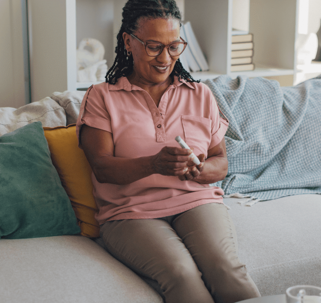 Image of a person using an auto-injector pen